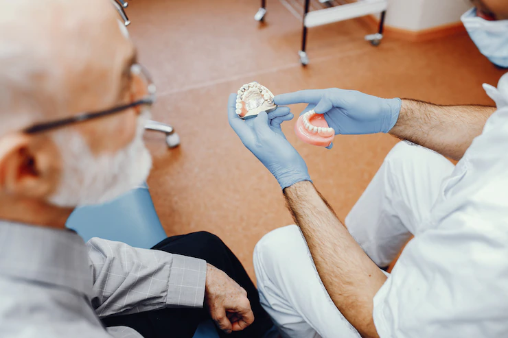 Dentista explicando la funcionalidad de la prótesis dental al paciente